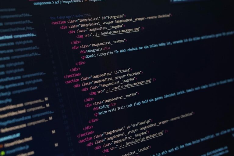 Close-up view of HTML code displayed on a dark screen, showcasing coding concepts.