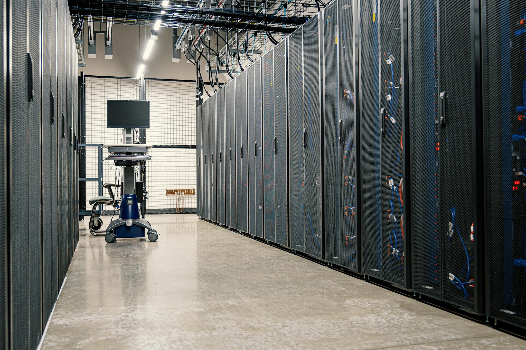 Steel framework cabinets housing servers networking devices and cables in contemporary equipped data center